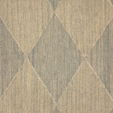 A close-up of a handwoven rug pattern featuring a diamond argyle design in beige and muted gray-blue tones.