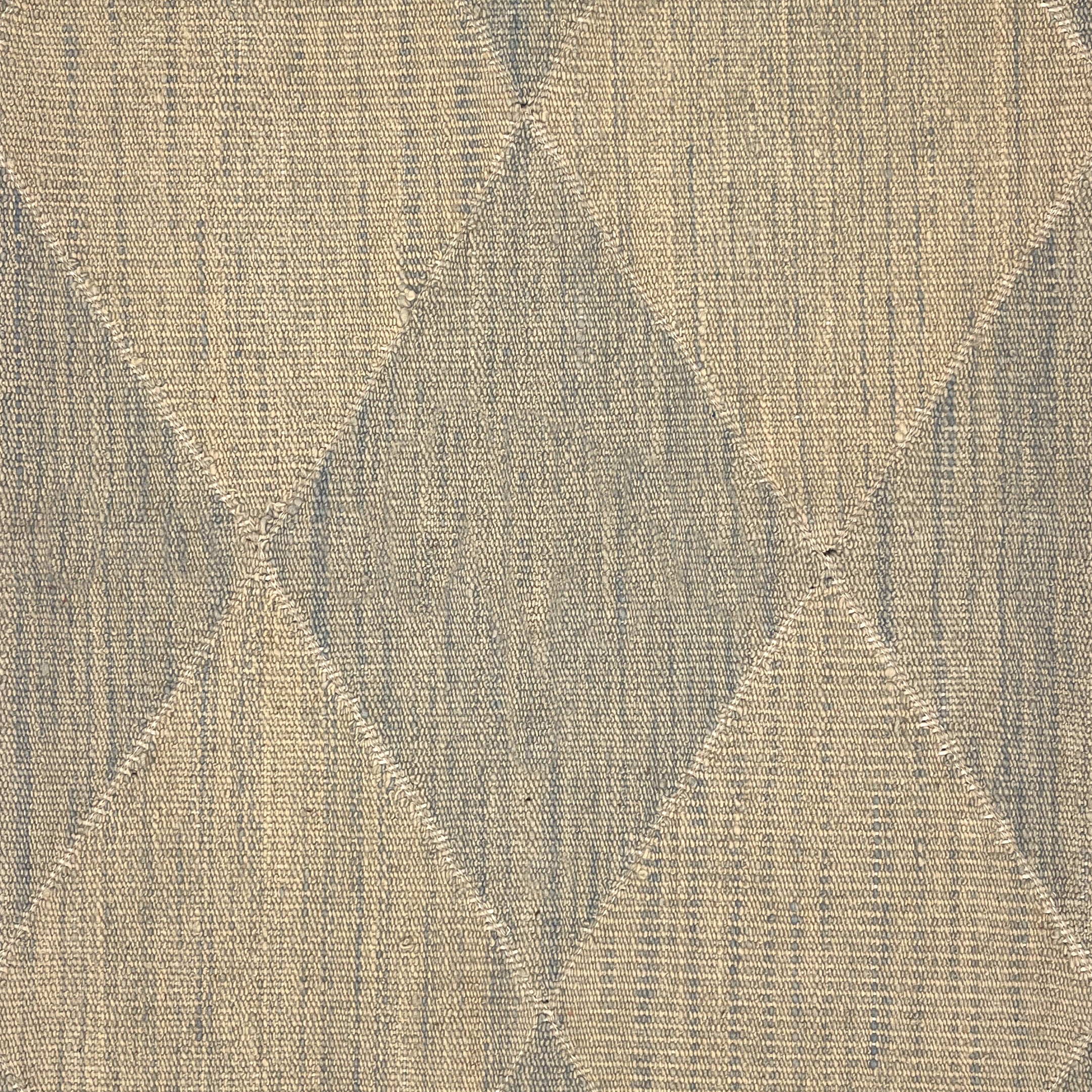 A close-up of a handwoven rug pattern featuring a diamond argyle design in beige and muted gray-blue tones.
