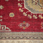 Decorative rug with geometric patterns on a red background
