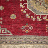 Decorative rug with geometric patterns on a red background