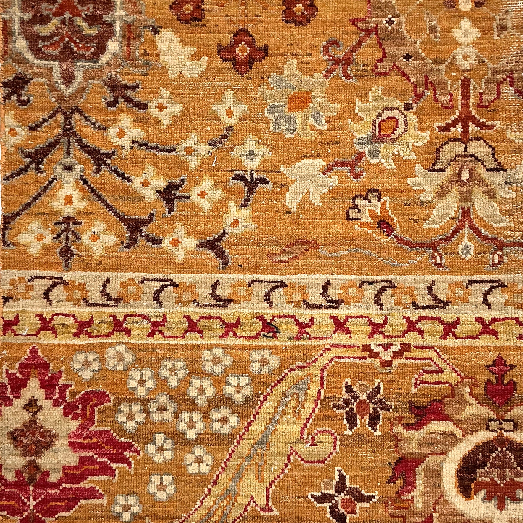 Decorative rug with intricate patterns and colors on a brown background