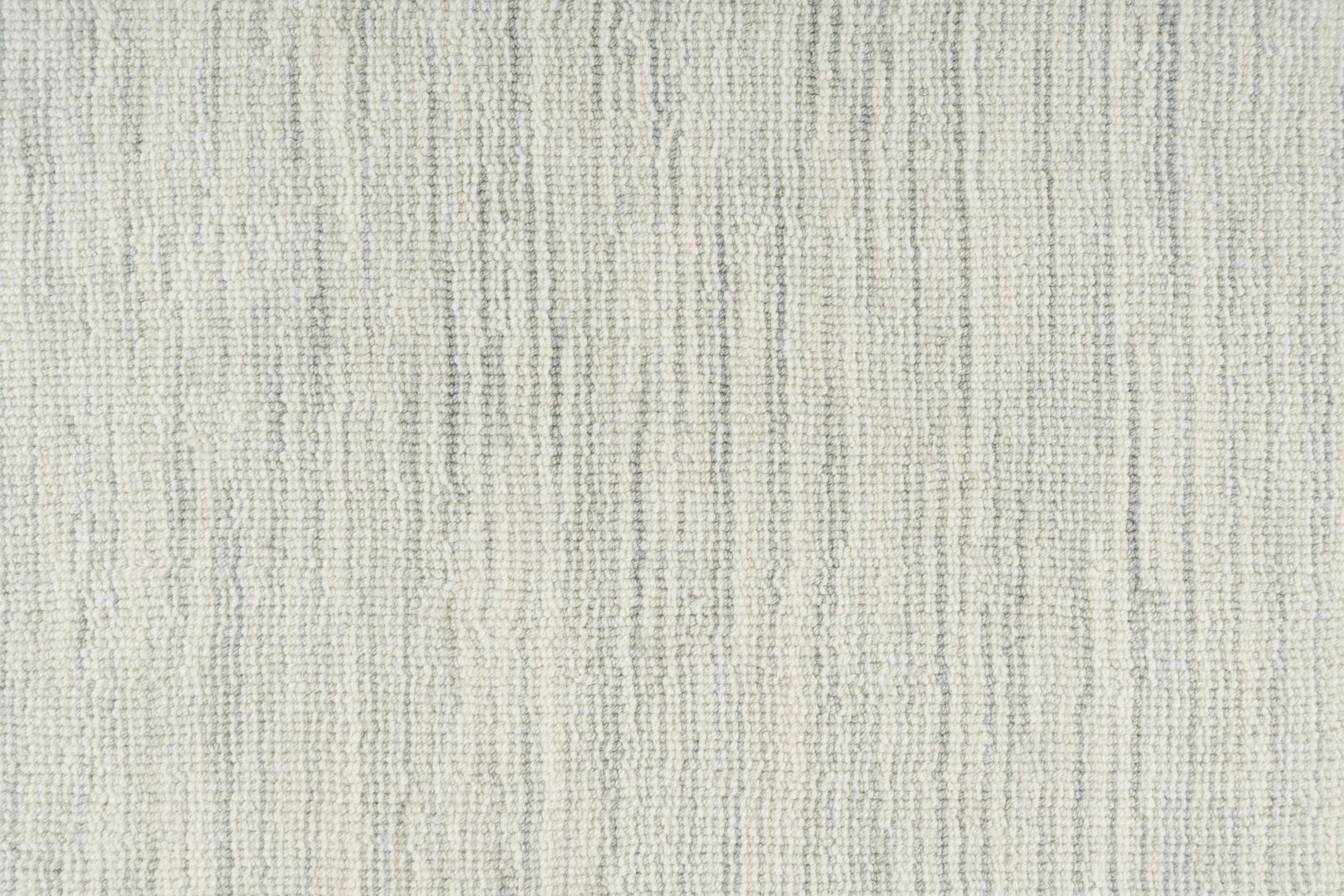 Broadloom carpet in a textural striated pale grey. 