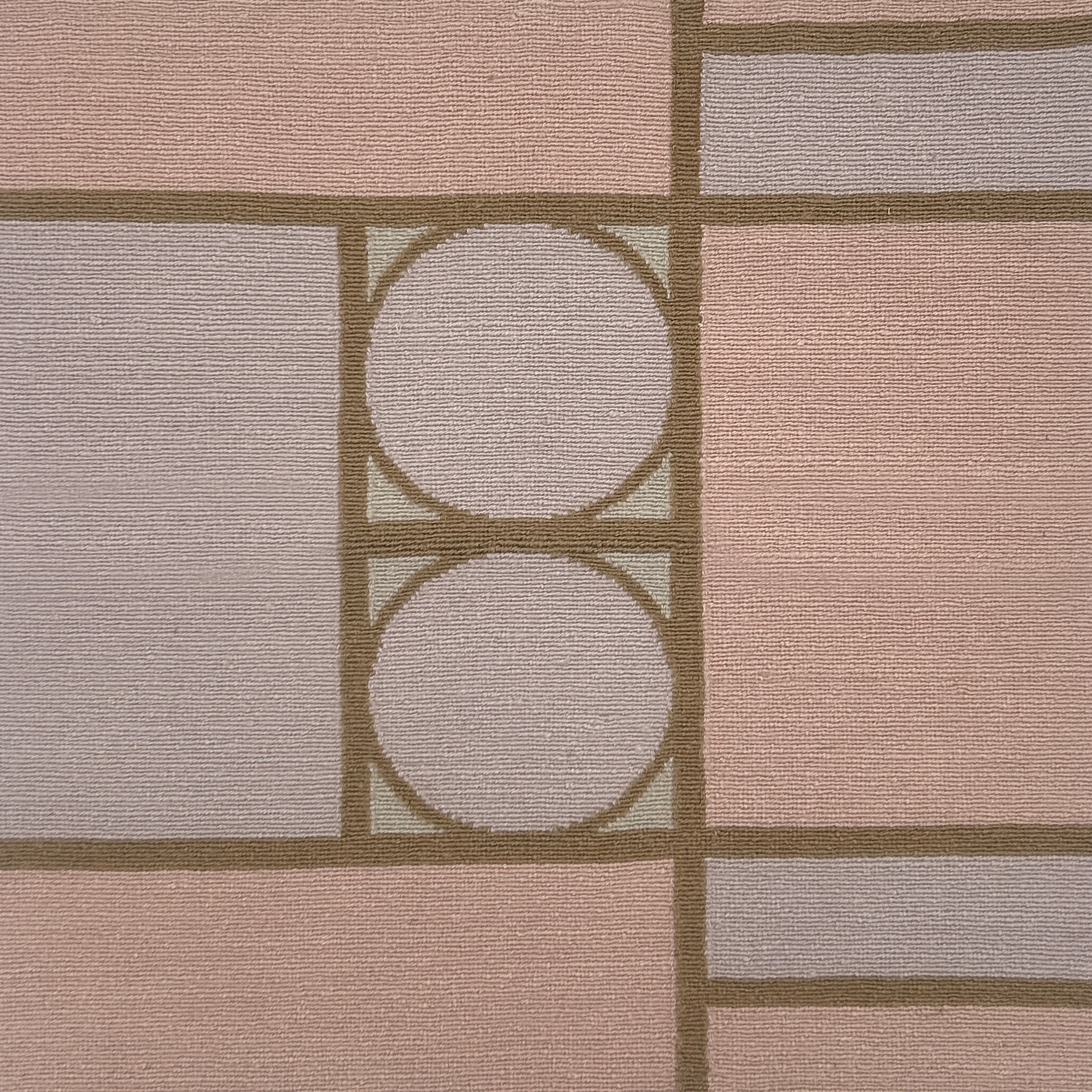 Handknotted rug with a bold geometric design in pink, purple and brown. 