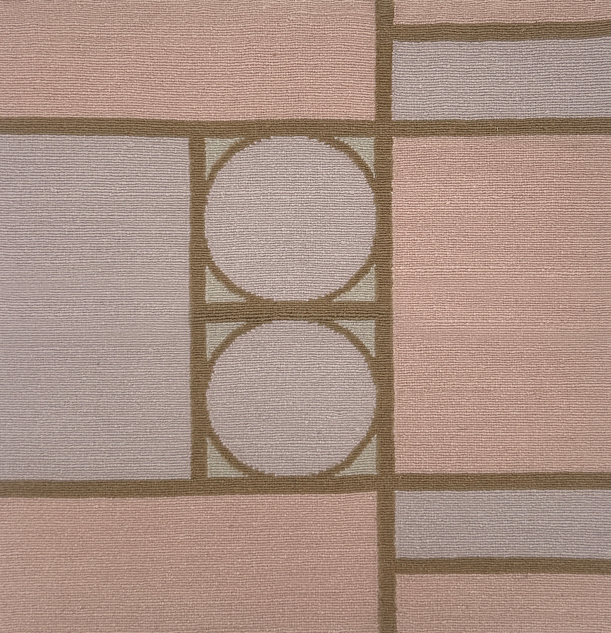 Handknotted rug with a bold geometric design in pink, purple and brown. 