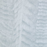 Detail of a wallpaper in an abstract textural pattern in metallic and blue.