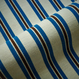 Close-up of fabric with blue and black stripes on a beige background