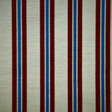 Striped fabric with red and blue vertical stripes on a beige background
