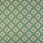 Detail of fabric in a playful floral grid print in green, yellow and blue on a white field.