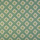 Detail of fabric in a playful floral grid print in green, yellow and blue on a white field.
