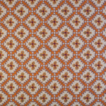 Detail of fabric in a playful floral grid print in orange, purple and green on a white field.