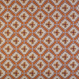 Detail of fabric in a playful floral grid print in orange, purple and green on a white field.