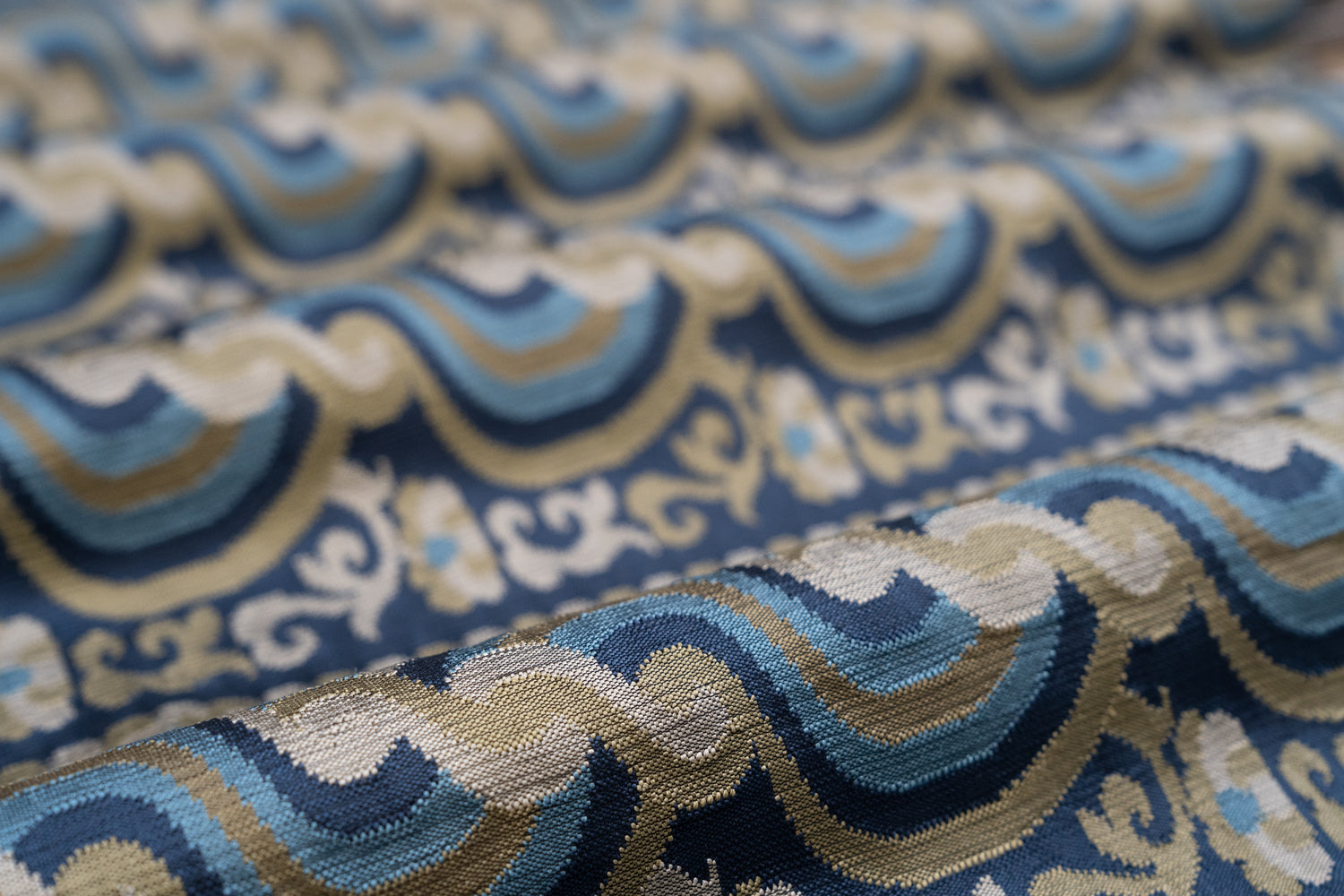 Close-up of patterned fabric with blue, beige, and brown colors.