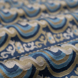Close-up of patterned fabric with blue, beige, and brown colors.