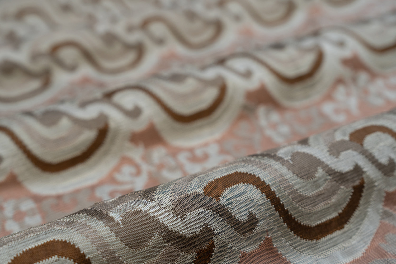 Close-up of textured fabric with wavy pattern on a pink background