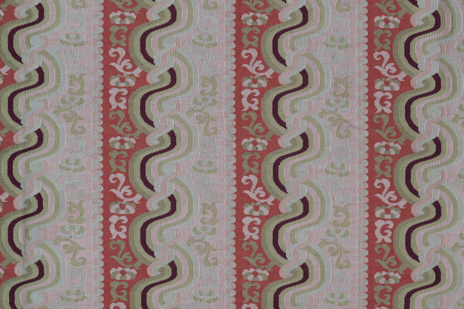 Handwoven silk fabric with scrolling stripe design in pink, red, tan, purple and cream. 