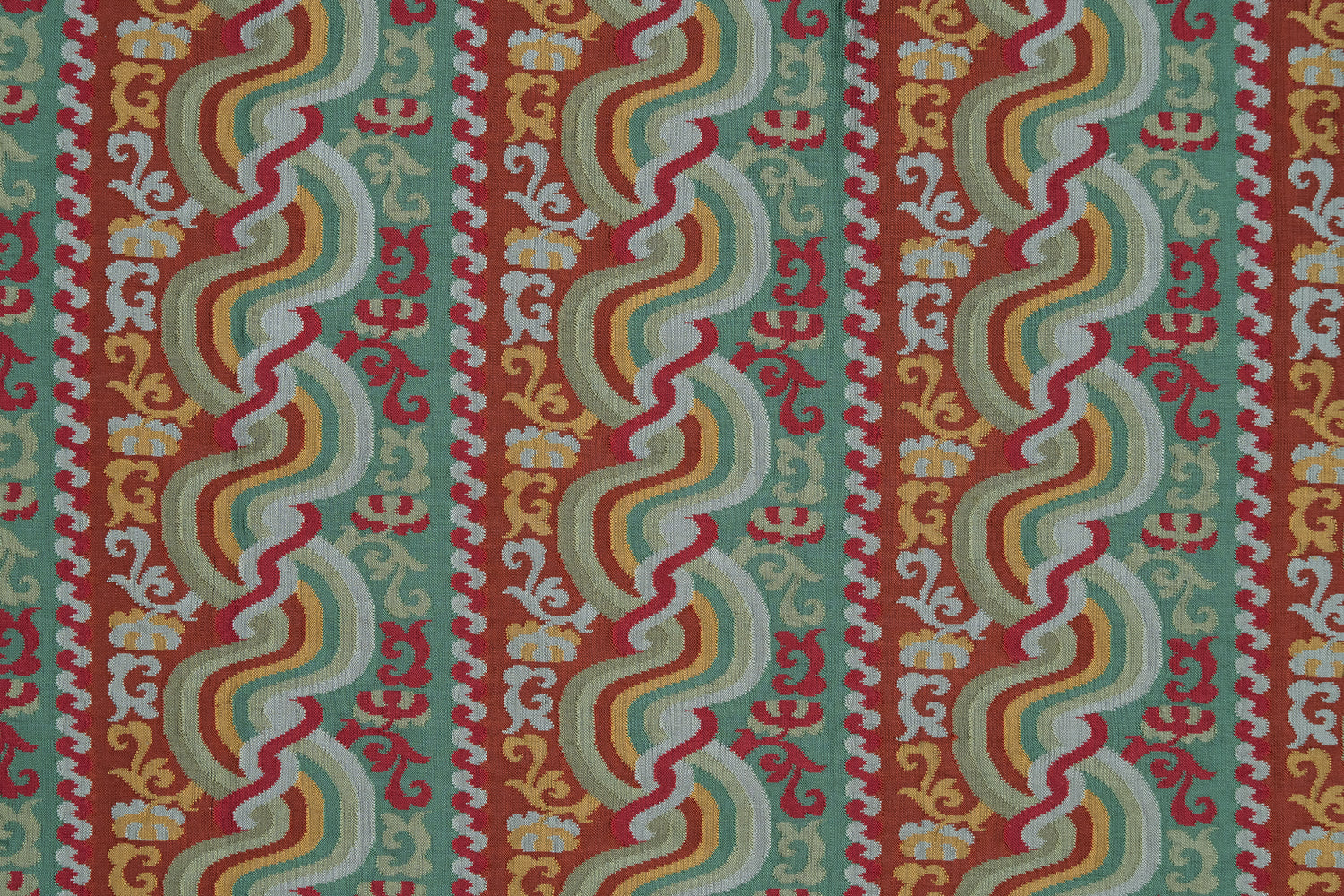 Handwoven silk fabric with scrolling stripe design in red, green, yellow and white. 