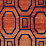 A flatweave rug with a melange of light orange to darker orange and a dark blue contemporary lattice pattern.