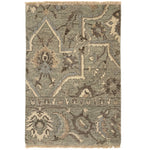 Handknotted rug in ornate damask pattern in blue, grey and cream.