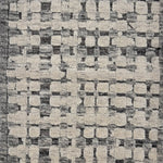 Handknotted rug sample in a textural geometric pattern in grey and ivory.