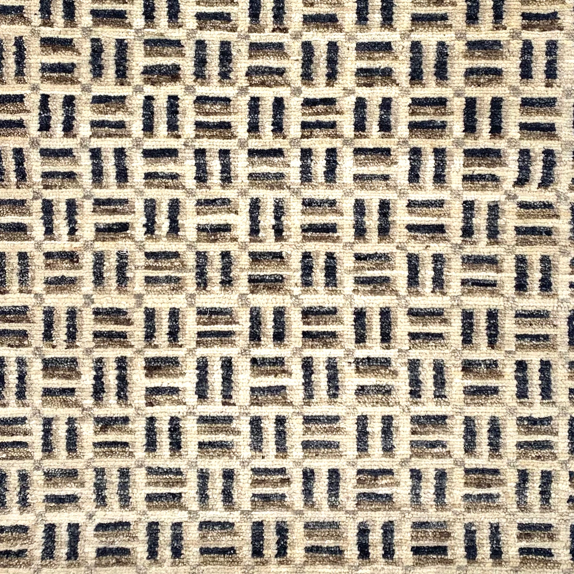 Handknotted rug in small scale geometric design in shades of grey and white. 