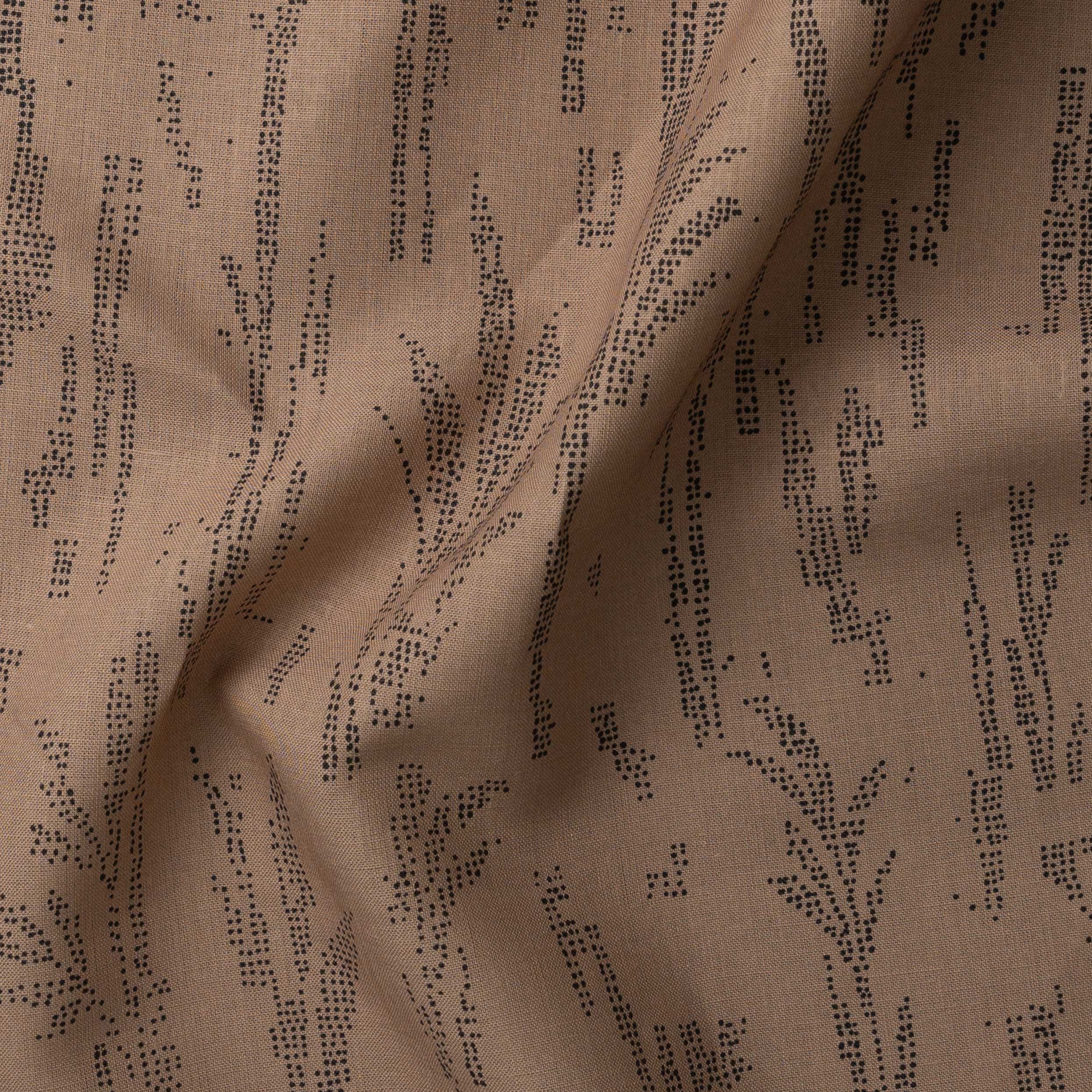 Detail of gently draped printed fabric with a black pointillist wheat frond pattern on a warm brown background. 
