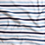 Close up of gently draped striped woven Indoor-Outdoor fabric in white, light blue navy and dark blue. 