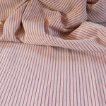 Draped close-up of pink and white striped fabric