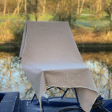 Red and white striped  fabric draped over a chair with a natural background