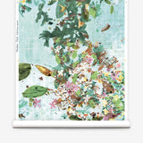 Roll of wallpaper with a floral and leaf pattern on a light blue background