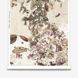 Roll of wallpaper with floral and leaf pattern on a beige background