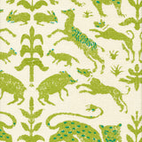 Detail of fabric in a playful animal and botanical print in green and blue on a cream field.