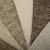 Close-up of textured carpet swatches in beige, brown, and gray.