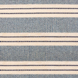 Broadloom carpet in a wide stripe in blue and cream with navy accent stripes. 