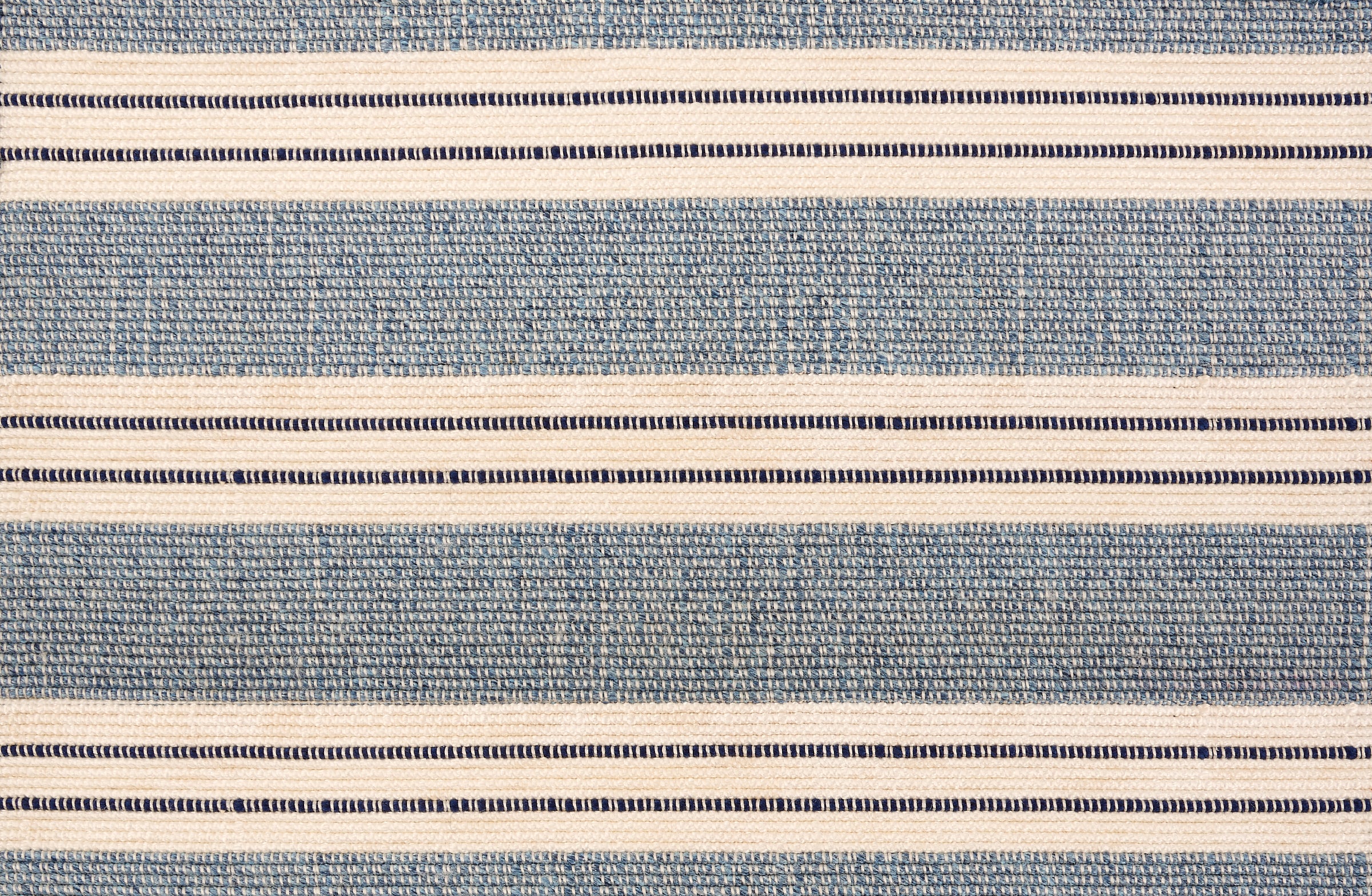 Broadloom carpet in a wide stripe in blue and cream with navy accent stripes. 