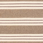 Broadloom carpet in a wide stripe in light brown and cream with dark brown accent stripes. 