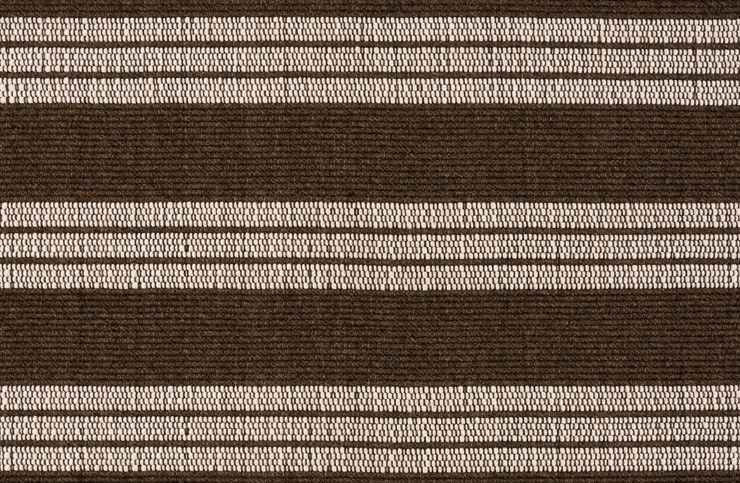 Broadloom carpet in a wide stripe in dark brown and cream with dark brown accent stripes. 