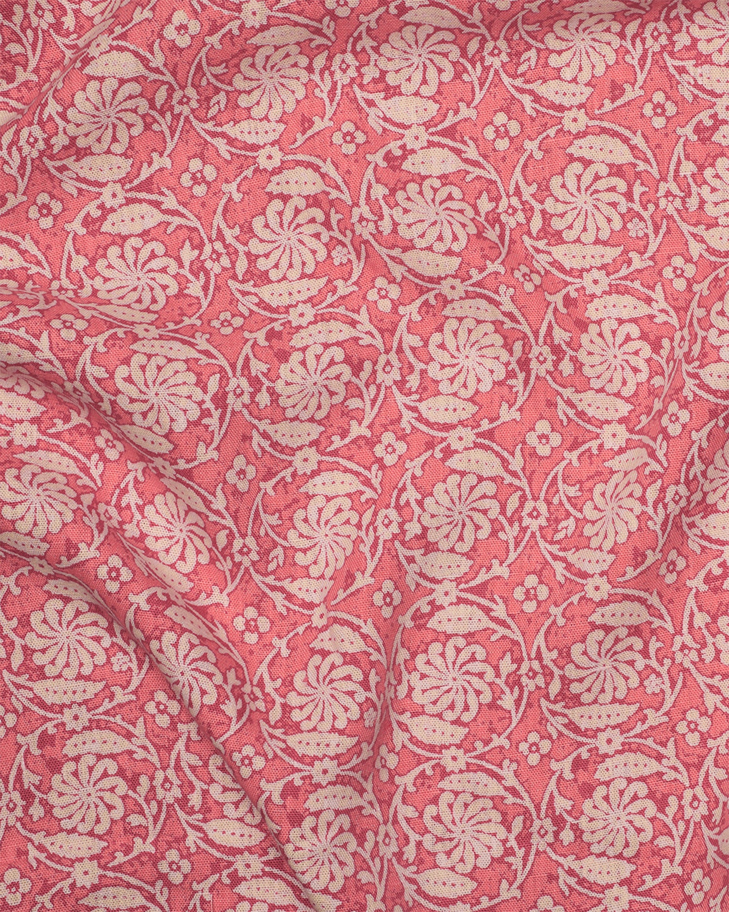 Patterned fabric with floral & vine design on a pink background