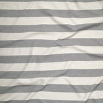 Close up of gently draped woven Indoor-Outdoor fabric with wide stripes in white and charcoal grey.