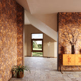 Modern interior with brown floral wallpaper, stone floors, potted plants and decorative cabinet.