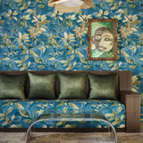 Living room with floral wallpaper, green sofa, and a clear glass table.