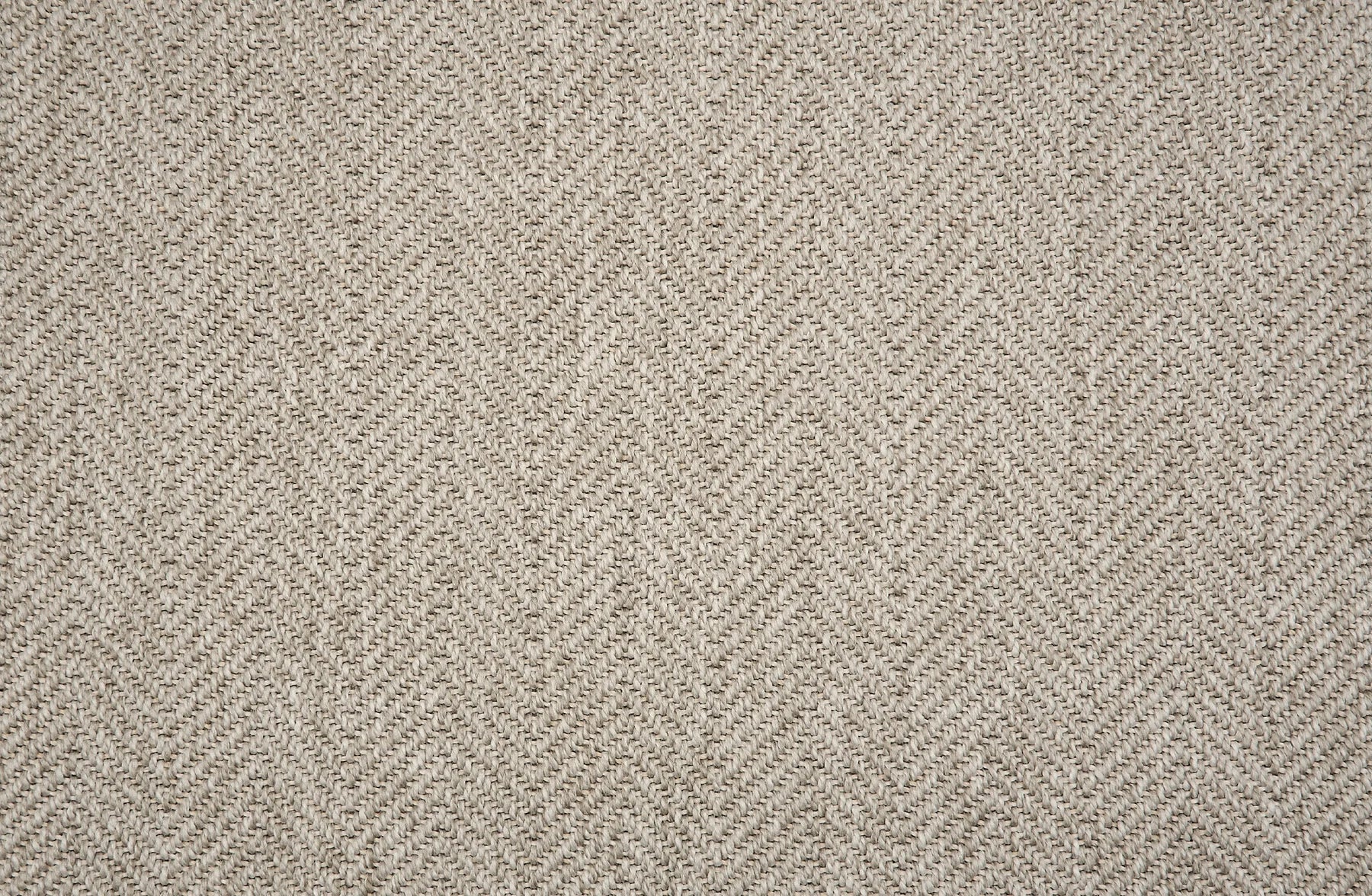 Textural performance broadloom carpet in herringbone design in grey.