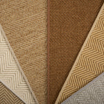Collection of woven rugs in beige, brown, and gray.