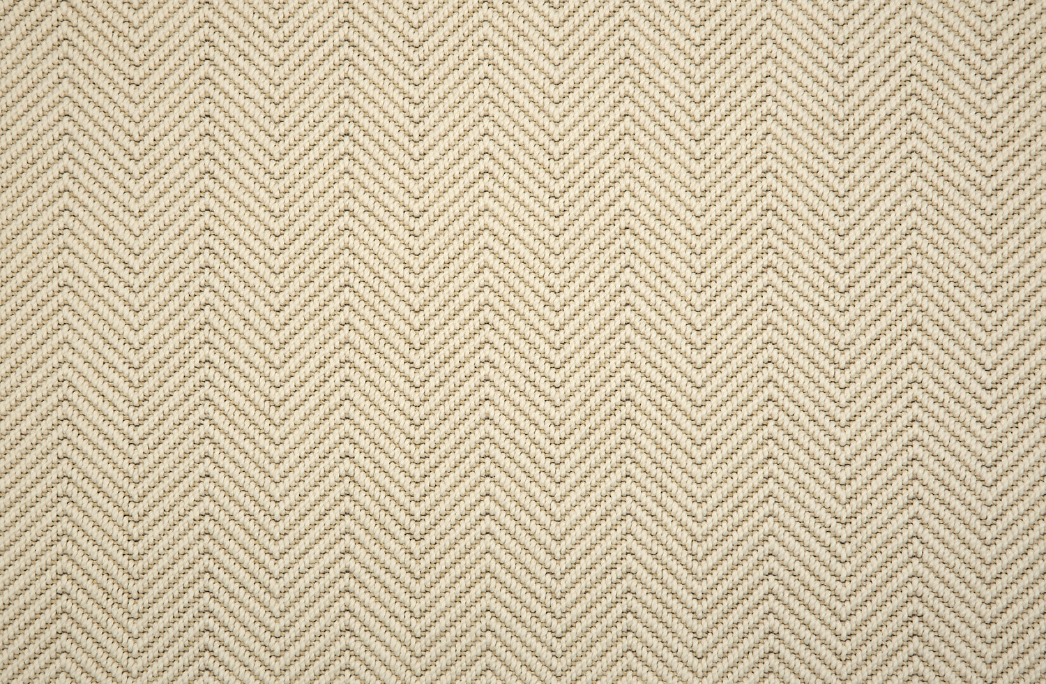 Textural performance broadloom carpet in herringbone design in cream.
