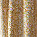 Drapped printed linen in a wavy floral stripe design in yellow on cream.