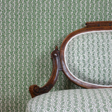 Wallpaper roll in a wavy floral stripe design in white on green