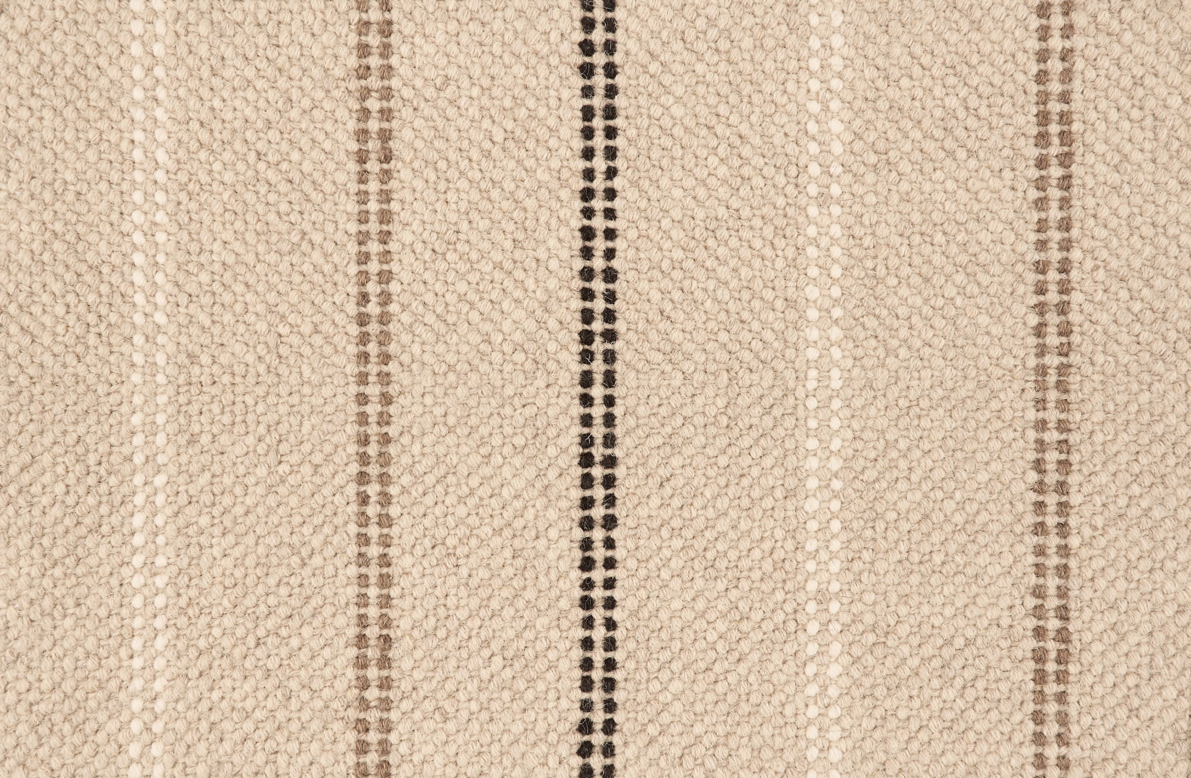 Broadloom carpet in a neutral with widely spaced stripes in shades of brown and cream.