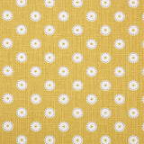 Detail of fabric in a playful dot print in white and gray on a mustard field.