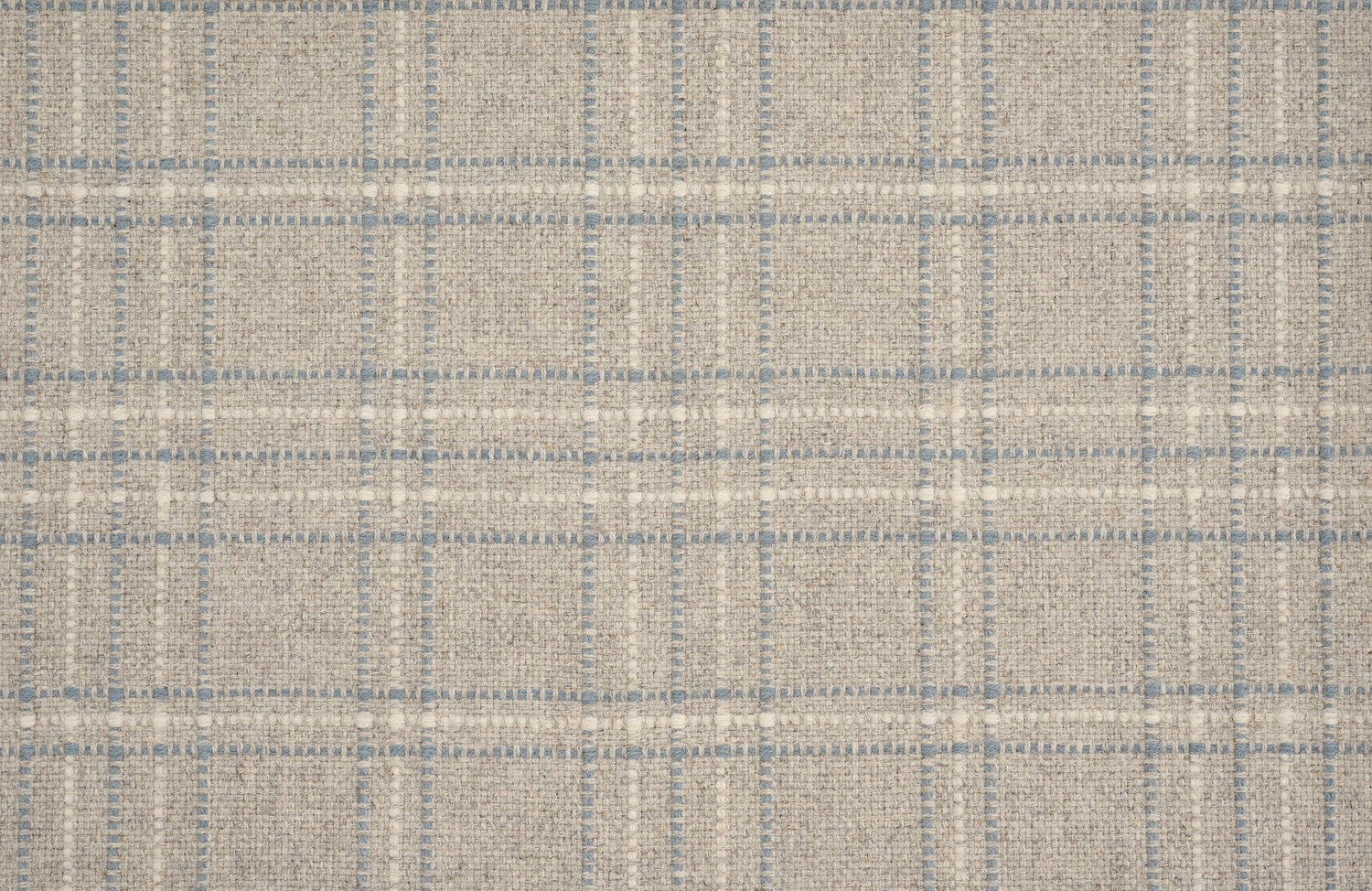 Broadloom carpet with windowpane plaid pattern in white and blue on a field of light grey. 