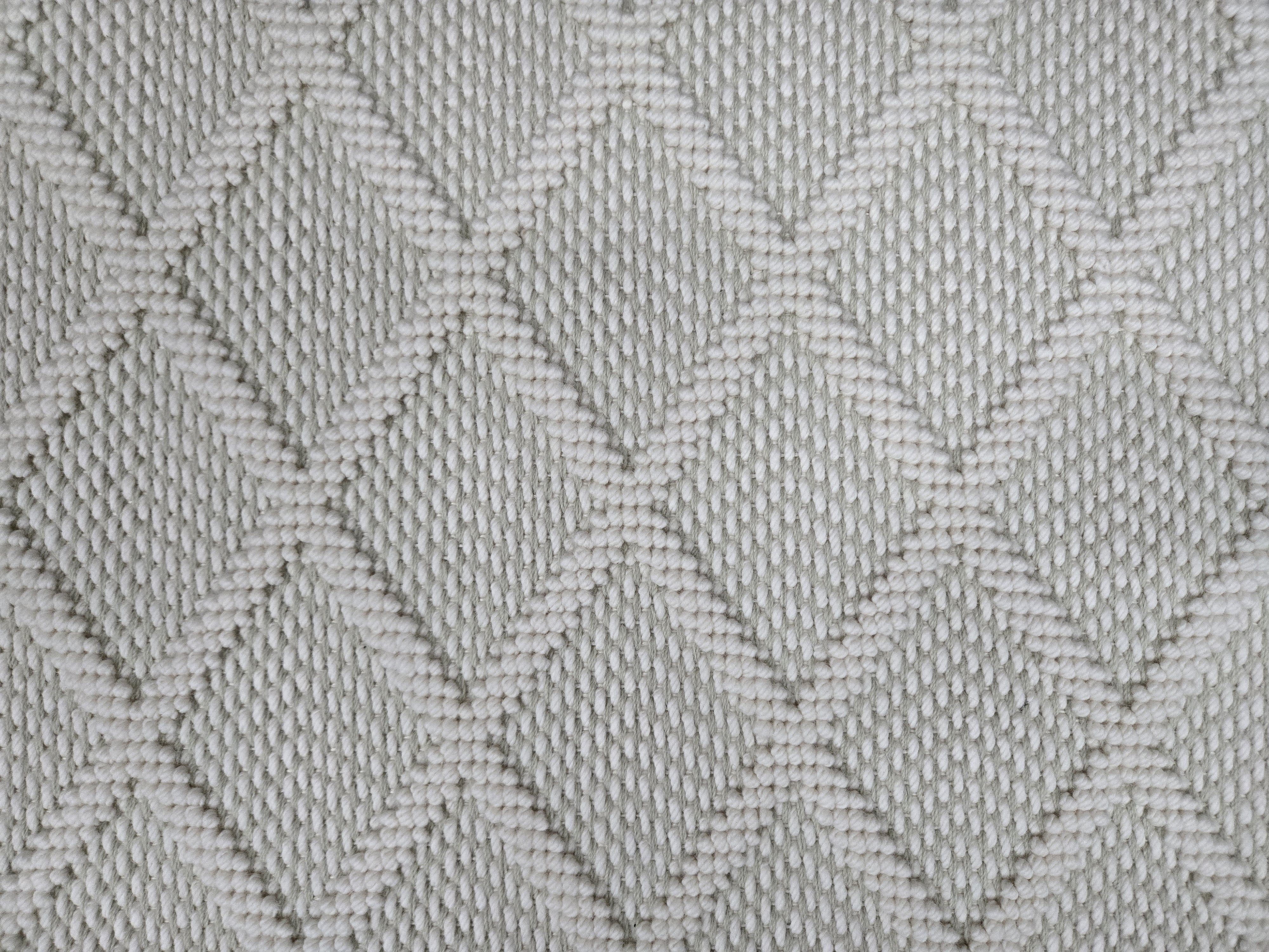 Broadloom carpet in a dimension diamond lattice in cream and grey-green