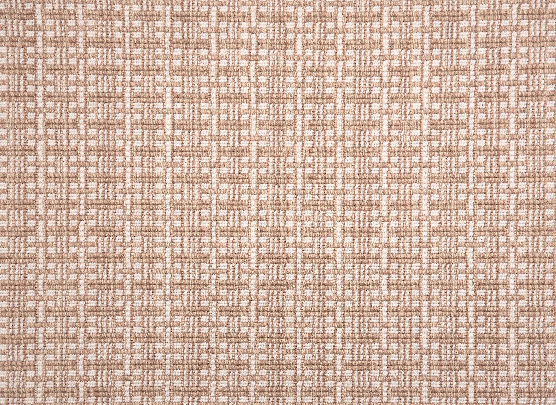 A close-up of broadloom carpet with a textured basketweave pattern in warm cream and clay pink tones.